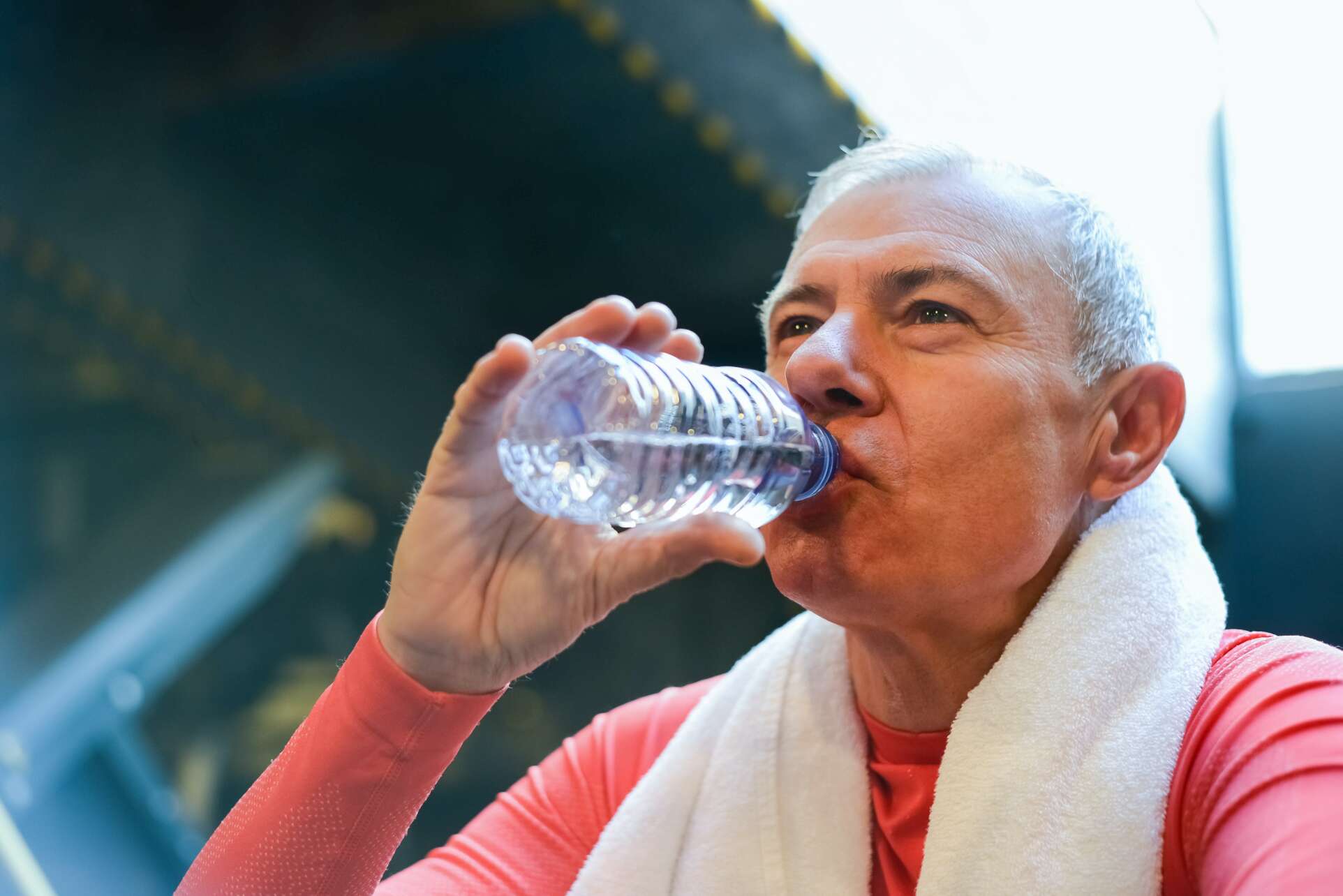 Man drinking from plastic water bottle